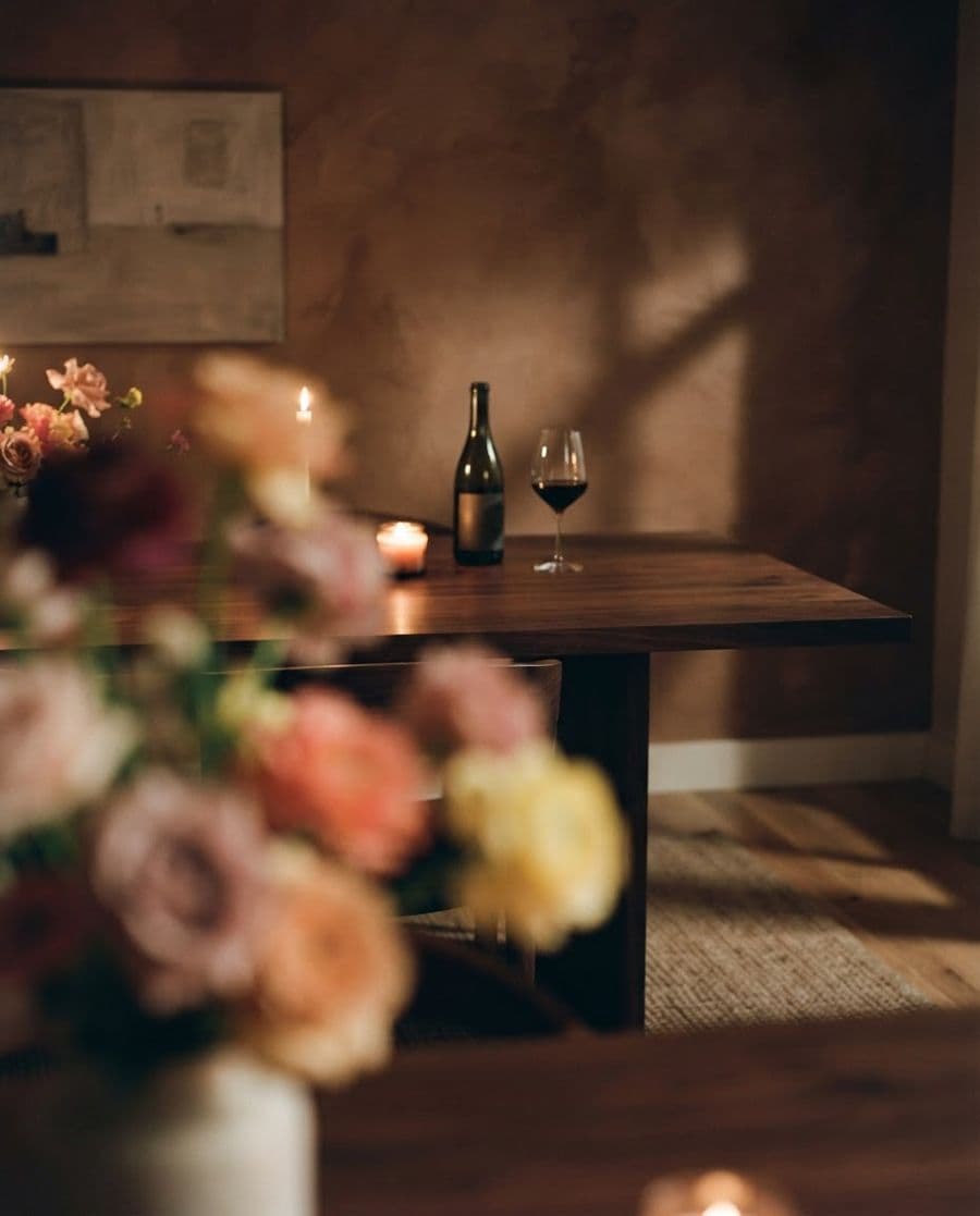 A dark dining room, flowers on the table